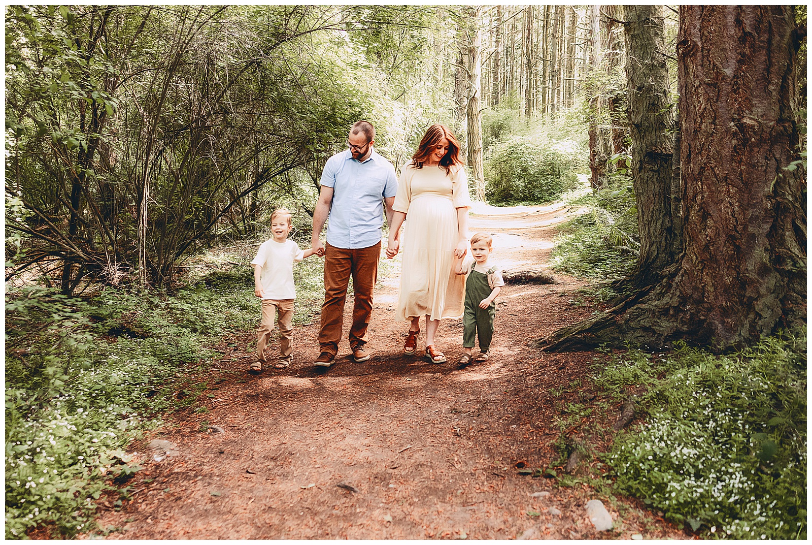 photos of pregnant mom, husband, and two kids walking through a forest